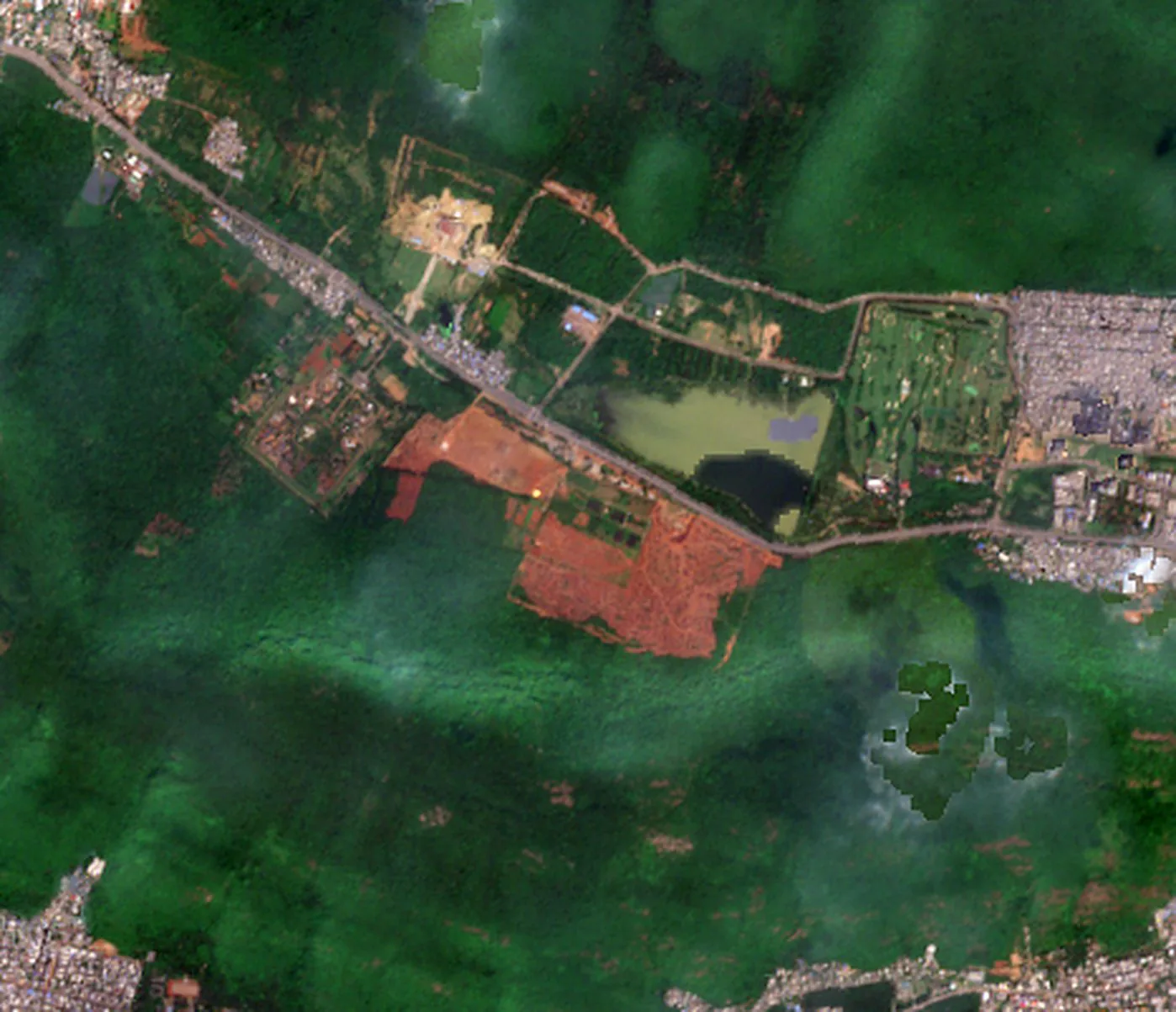 Adavivaram on 13 October 2026: a large bare patch on the lower slope of a forested hill, beside Mudasarlova reservoir.